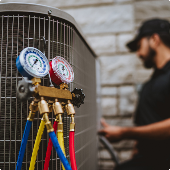 Manifold gauge set connected to an outdoor air conditioning unit during a cooling service call