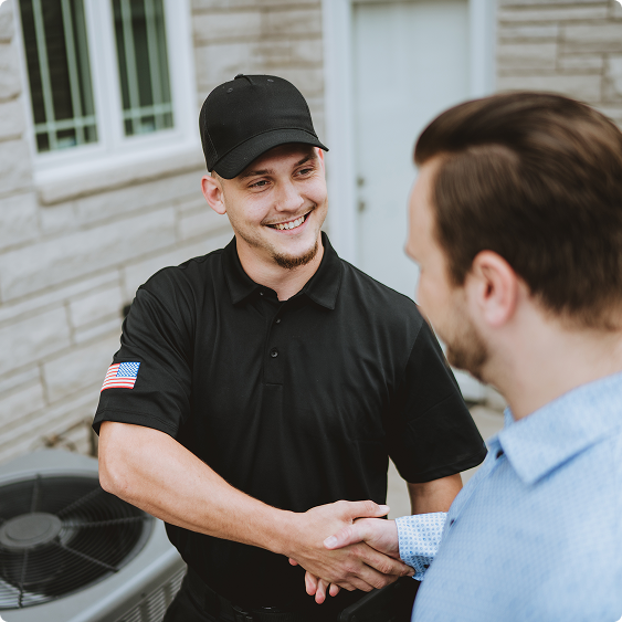 Drake Heating & Air technician shaking hands with a homeowner outside their house