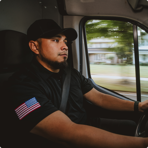 Drake Heating & Air technician driving a service van to a call