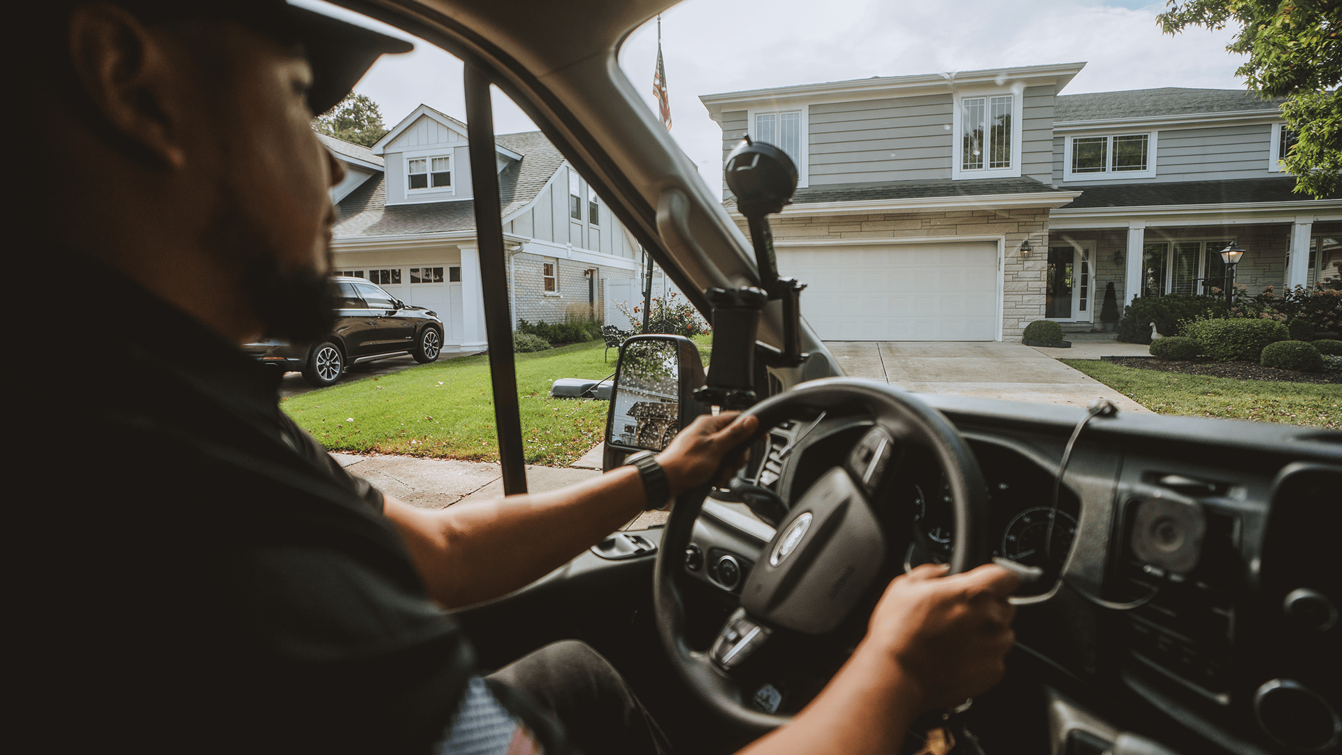 Drake Heating & Air technician driving a service van through a suburban neighbourhood