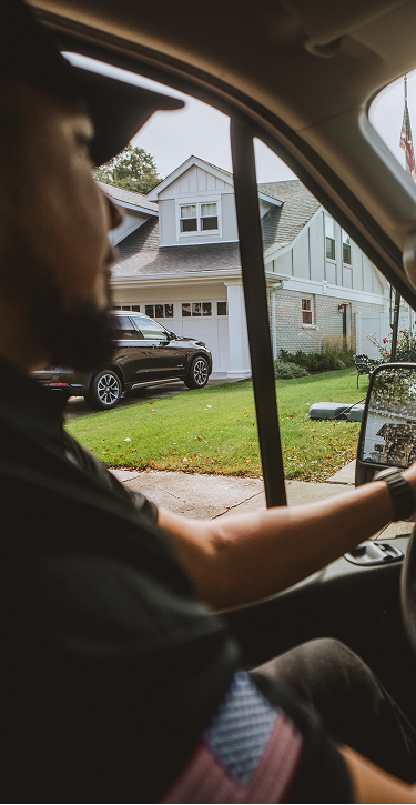 Drake Heating & Air technician driving a service van through a suburban neighbourhood